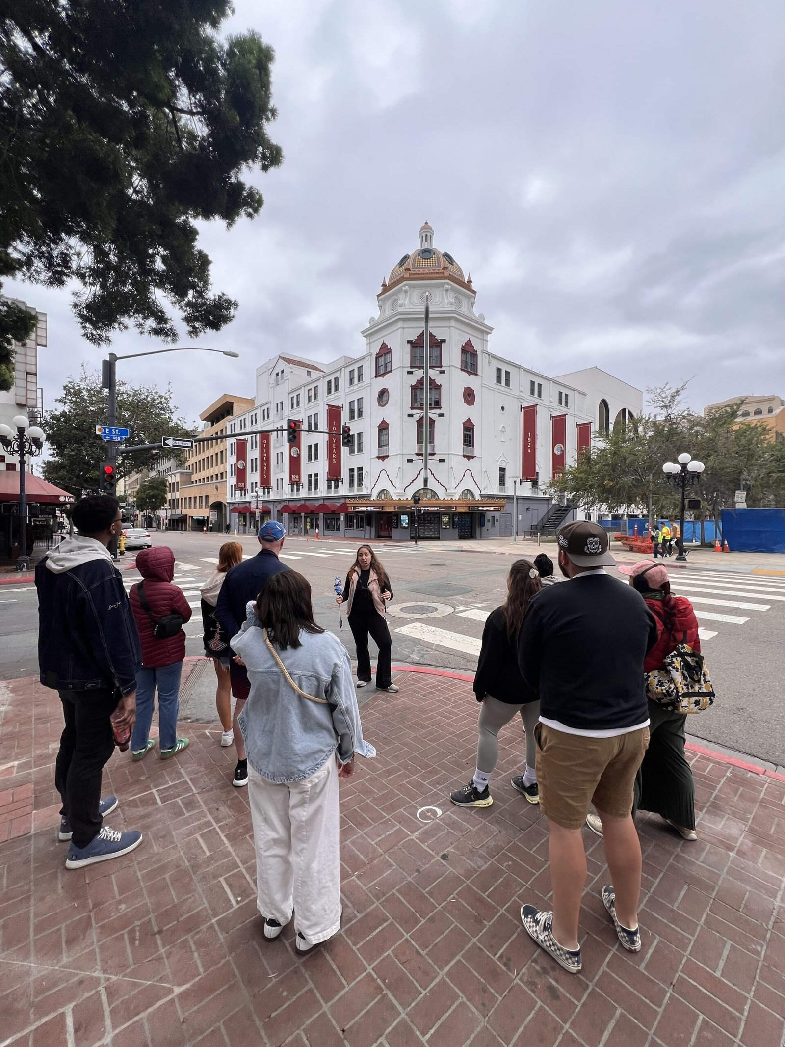 Balboa Theatre in San Diego, California, with a tour group gathered in front.