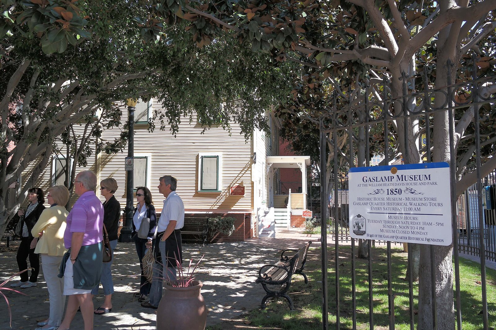 Davis-Horton House, San Diego's oldest home, and visitors with Gaslamp Museum signage.